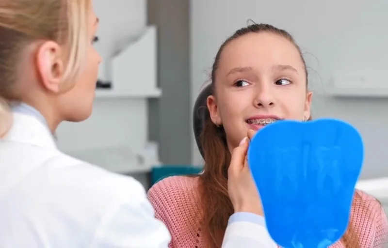 Young girl with braces at orthodontist appointment in Luxembourg.
